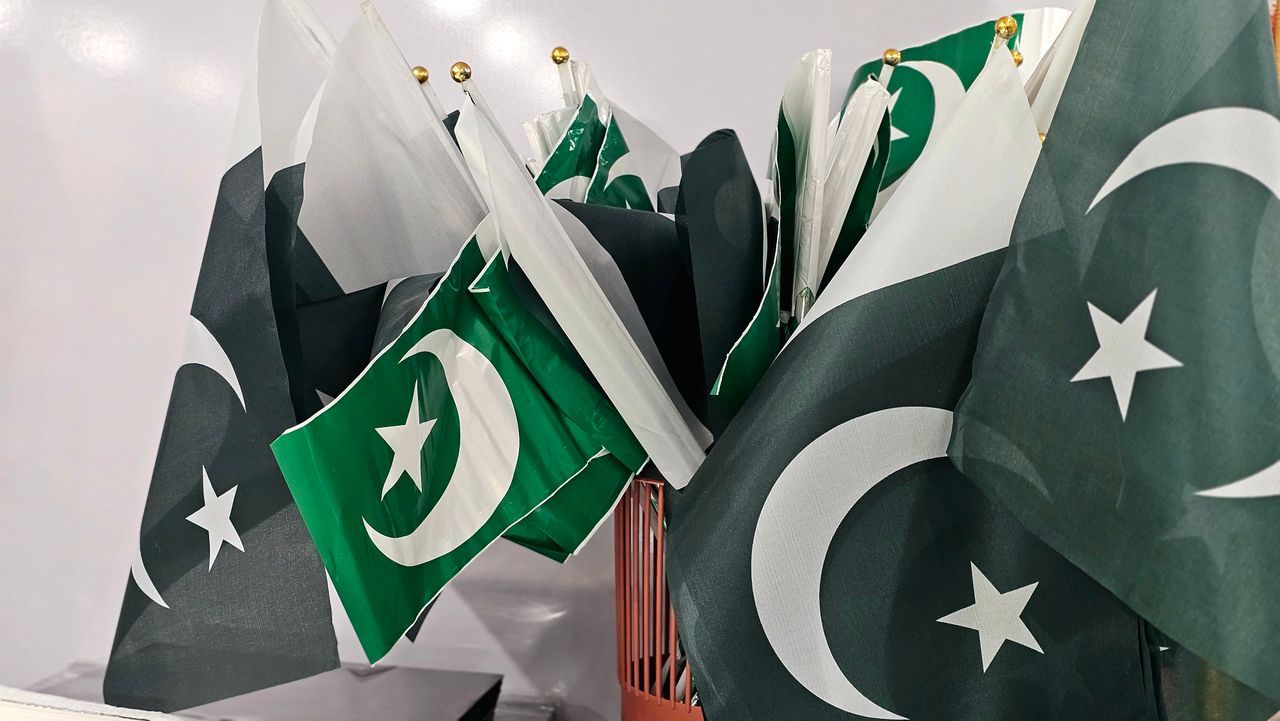 Home A variety of Pakistani flags grouped together indoors, emphasizing national pride.